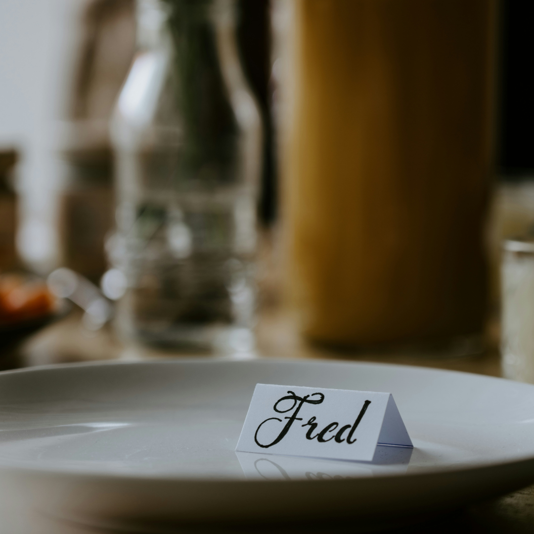 A serving dish staged the night before, with a handwritten place card, as part of a Thanksgiving timeline.